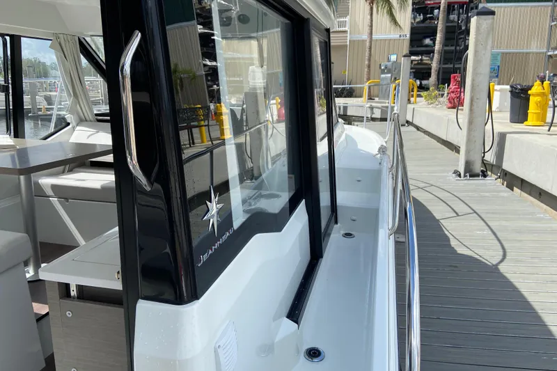 Slide: The Image of 2026 Jeanneau NC 895 Series 2 docked, showcasing sleek design and spacious interior. - 59