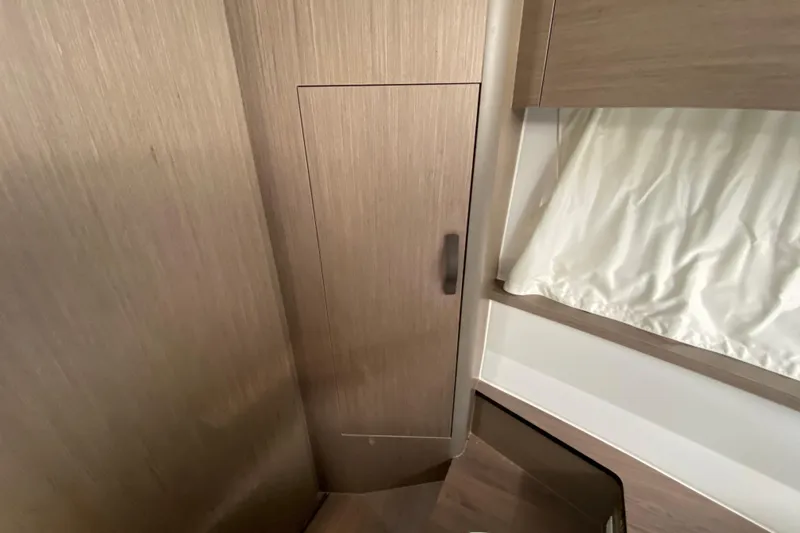 Slide: The Image of Interior of 2026 Jeanneau NC 895 Series 2, featuring wooden cabinetry and curtain. - 39