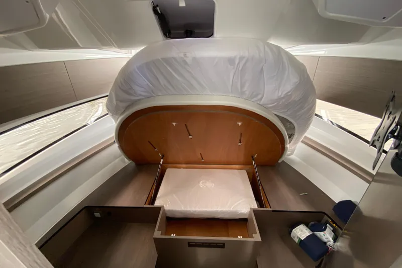 Slide: The Image of Interior cabin of 2026 Jeanneau NC 895 Series 2 boat, featuring a convertible bed. - 43