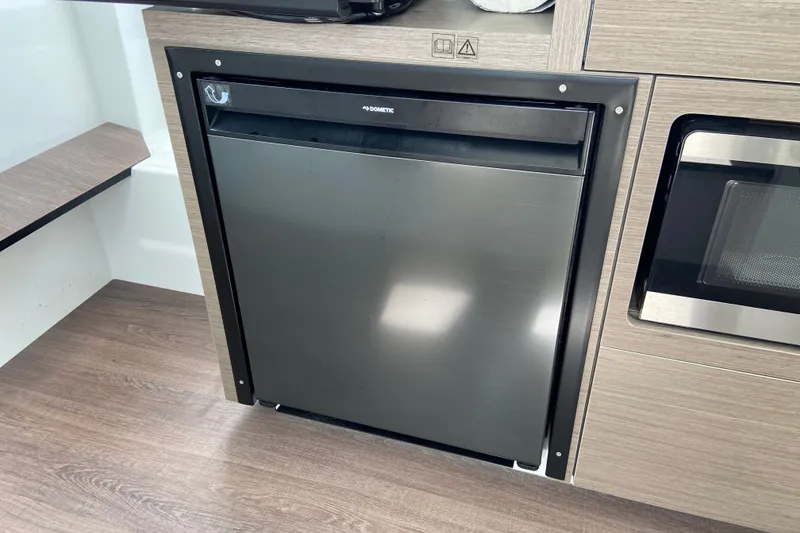 Slide: The Image of Compact kitchen area in the 2026 Jeanneau NC 895 Series 2 boat. - 35