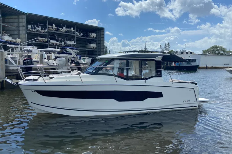 Slide: The Image of 2026 Jeanneau NC 895 Series 2 boat docked at marina under blue sky. - 3