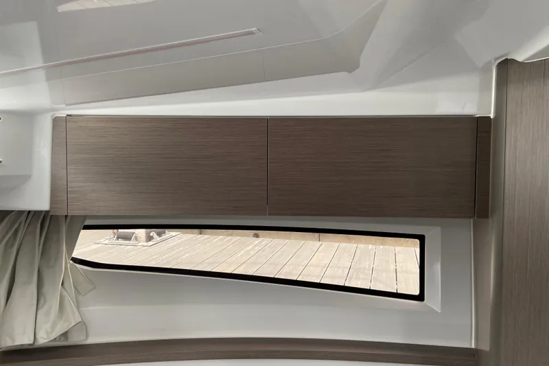 Slide: The Image of Interior view of 2026 Jeanneau NC 895 Series 2, featuring sleek wooden cabinetry and window. - 46