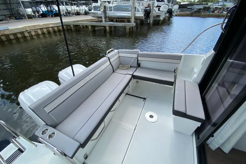 Slide: The Image of 2026 Jeanneau NC 895 Series 2 boat with spacious seating area by the water. - 11