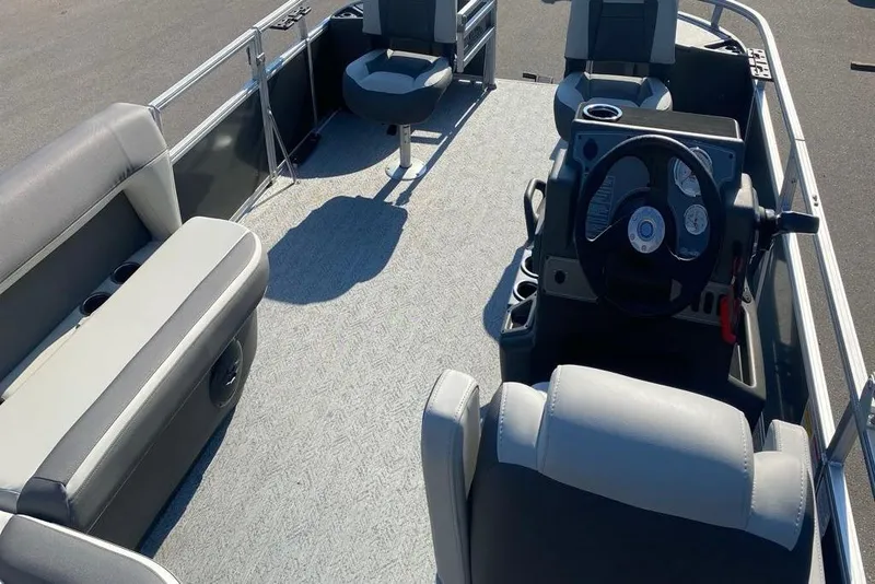 Slide: The Image of 2026 Sun Tracker Bass Buggy 18 DLX pontoon boat interior with seating and steering console. - 5