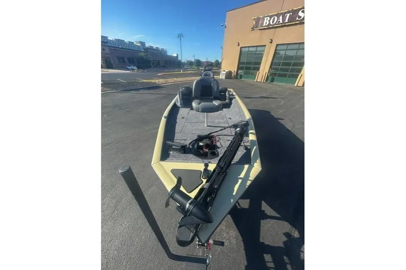 Slide: The Image of 2026 Tracker Pro Team 195 boat parked outside a boat store on a sunny day. - 4