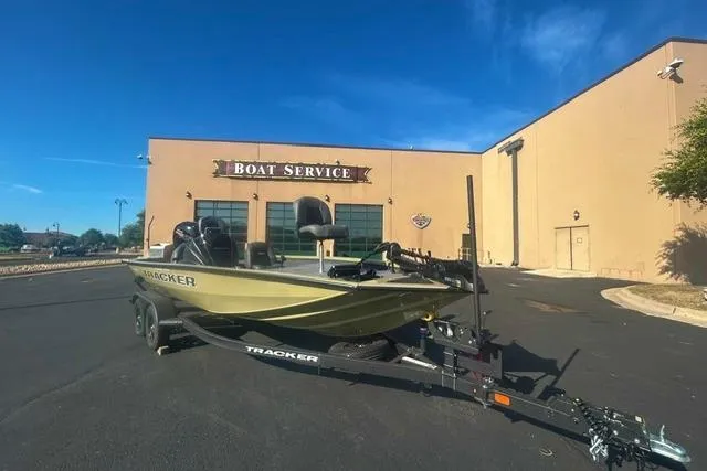 The Image of 2026 Tracker Pro Team 195 boat on trailer outside boat service building. - 0