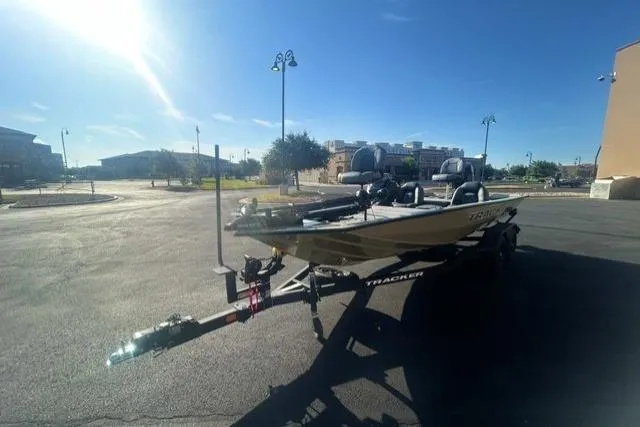 Slide: The Image of 2026 Tracker Pro Team 195 boat on trailer in sunny parking lot. - 2