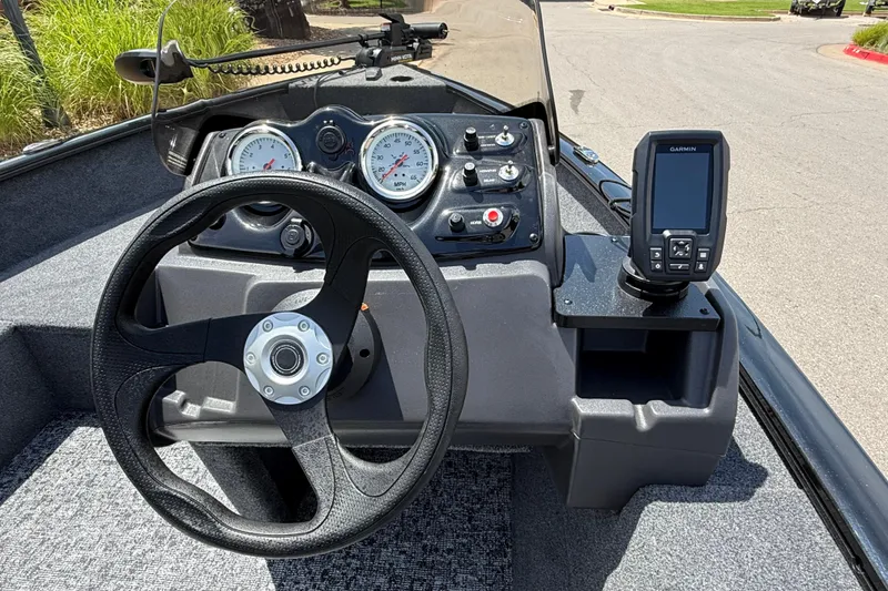 Slide: The Image of 2026 Tracker Super Guide V-16 SC boat dashboard with steering wheel and Garmin GPS. - 4