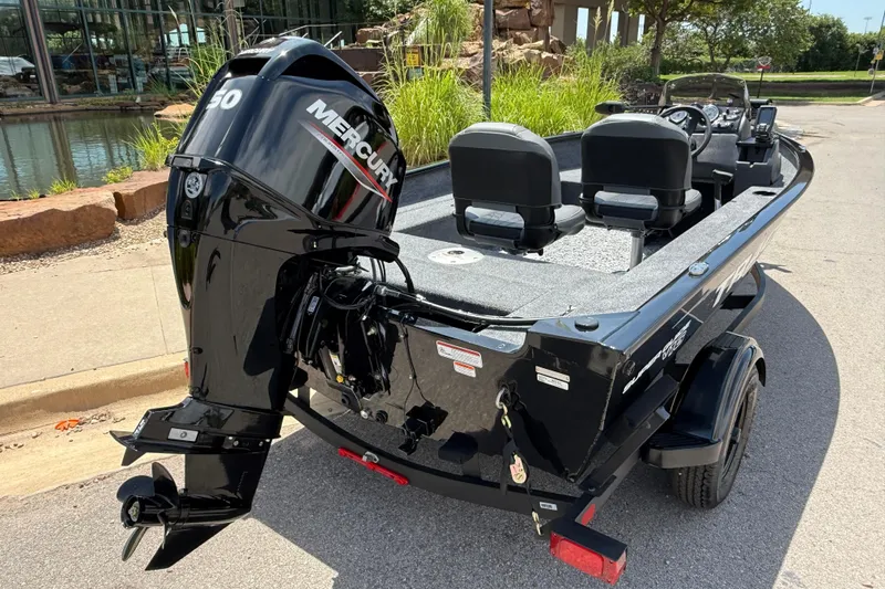 Slide: The Image of 2026 Tracker Super Guide V-16 SC boat with Mercury engine, parked outdoors. - 5