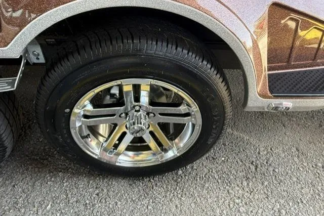 Slide: The Image of 2026 Ranger Z521R Cup-Equipped vehicle with shiny chrome wheel on asphalt surface. - 10
