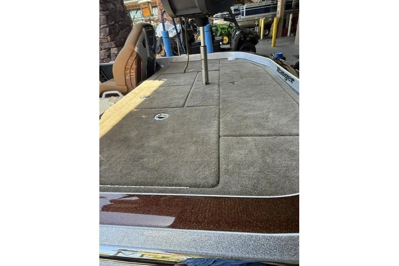 Slide: The Image of 2026 Ranger Z521R Cup-Equipped boat deck with carpeted surface and seating area. - 6