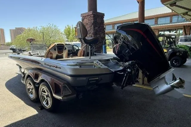 Slide: The Image of 2026 Ranger Z521R Cup-Equipped boat with powerful outboard motor in a showroom setting. - 1
