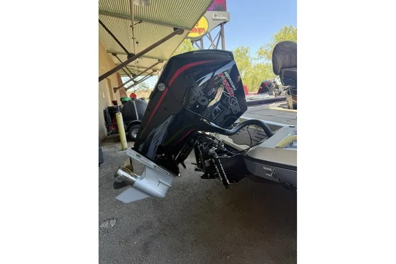 Slide: The Image of 2026 Ranger Z521R Cup-Equipped boat with powerful outboard motor in a shaded area. - 4