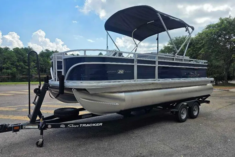 Slide: The Image of 2026 Sun Tracker SportFish 20 DLX pontoon boat on trailer, parked outdoors. - 3