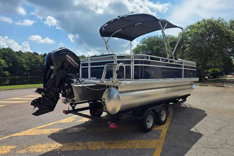 Slide: The Image of 2026 Sun Tracker SportFish 20 DLX pontoon boat on trailer, parked outdoors. - 5