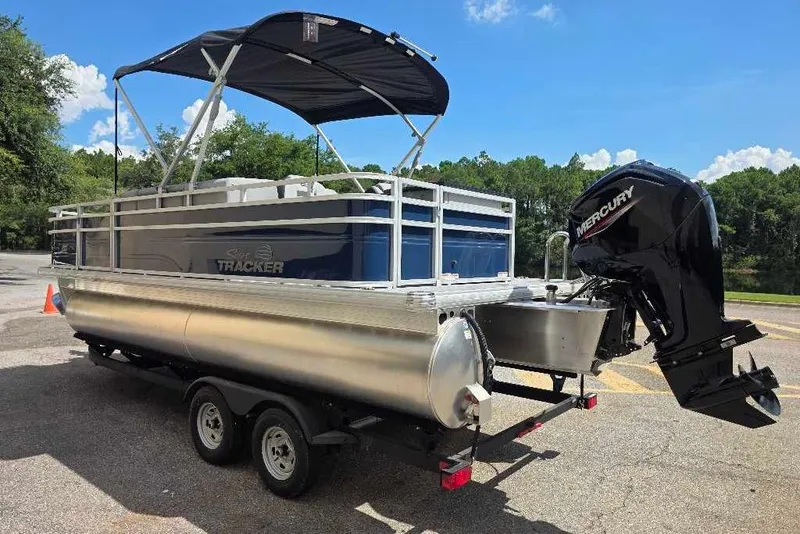 Slide: The Image of 2026 Sun Tracker SportFish 20 DLX pontoon boat with Mercury outboard motor on trailer. - 4