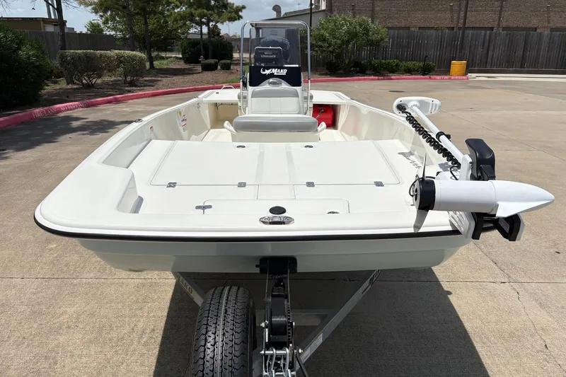 Slide: The Image of 2026 Mako Pro Skiff 17 CC boat on trailer, parked outdoors. - 1
