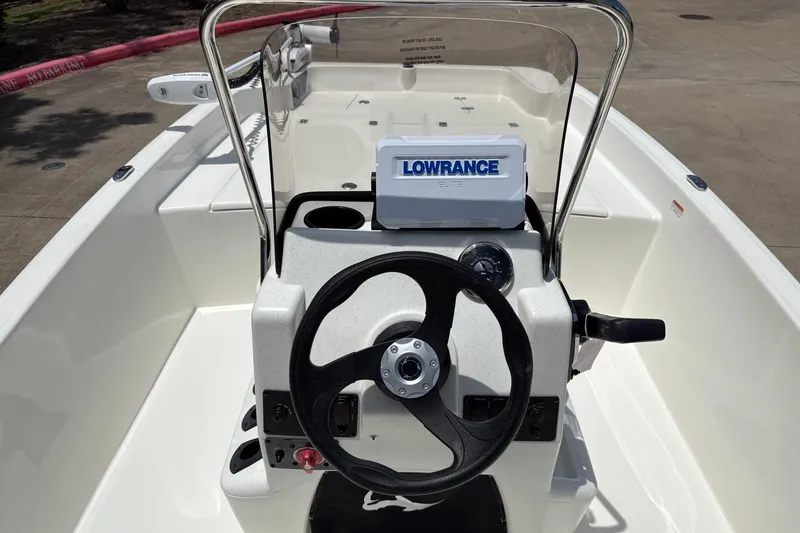 Slide: The Image of 2026 Mako Pro Skiff 17 CC boat console with Lowrance Elite system and steering wheel. - 6
