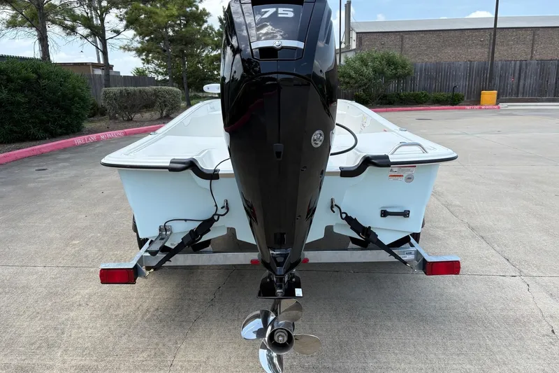 Slide: The Image of 2026 Mako Pro Skiff 17 CC boat on trailer, rear view with outboard motor. - 7