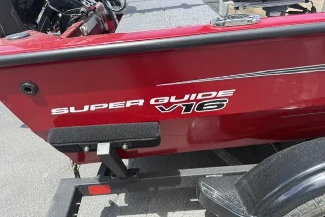 Slide: The Image of 2026 Tracker Super Guide V-16 T boat, red exterior, on a trailer. - 5