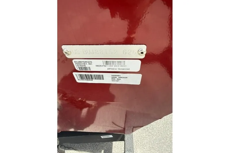 Slide: The Image of 2026 Tracker Super Guide V-16 T identification plate on red surface. - 11