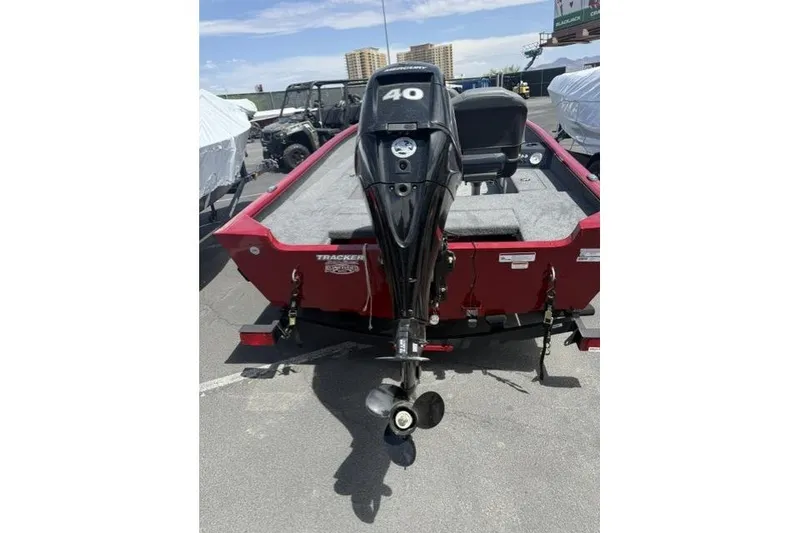 Slide: The Image of 2026 Tracker Super Guide V-16 T boat with 40 HP outboard motor, parked outdoors. - 4