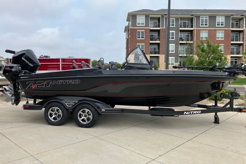The Image of 2026 Nitro ZV20 Pro boat on trailer, parked near modern apartments. - 0