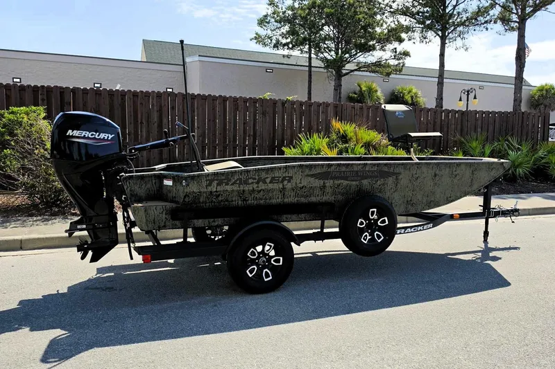 Slide: The Image of 2026 Tracker Grizzly 1650 T Prairie Wings Edition boat on trailer, parked outdoors. - 2