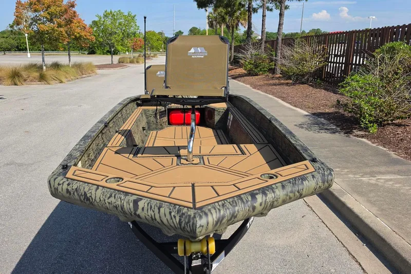 Slide: The Image of 2026 Tracker Grizzly 1650 T Prairie Wings Edition boat with camouflage design on a sunny day. - 11