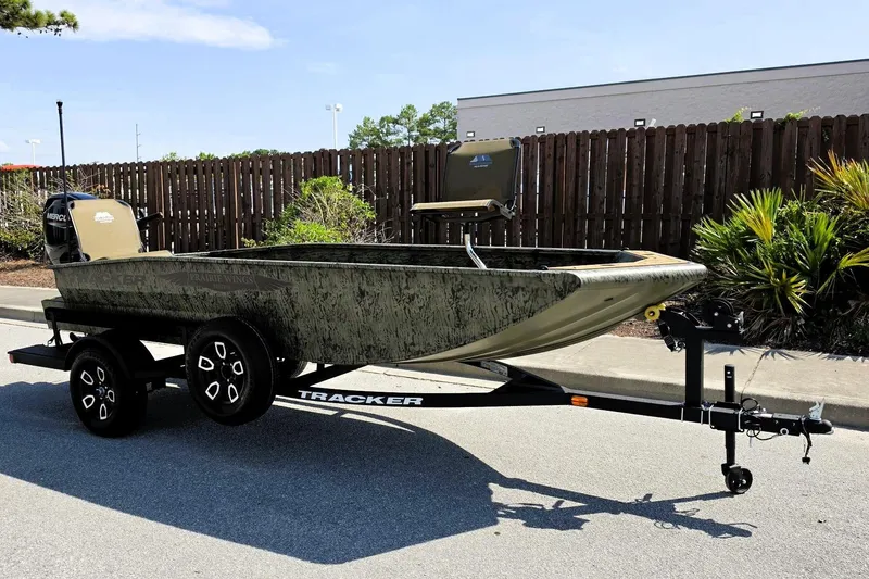 Slide: The Image of 2026 Tracker Grizzly 1650 T Prairie Wings Edition boat on trailer, parked outdoors. - 5