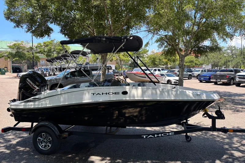 Slide: The Image of 2026 Tahoe T16 boat on trailer in sunny parking lot with trees. - 3