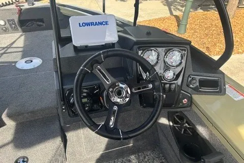 Slide: The Image of 2026 Tracker Targa V-19 WT boat dashboard with steering wheel and Lowrance display. - 13