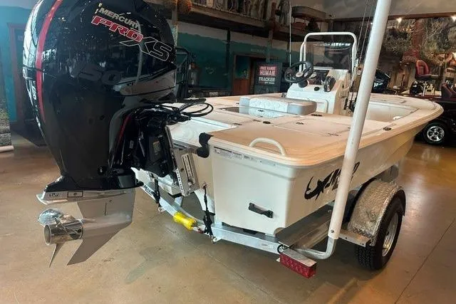 Slide: The Image of 2026 Mako 18 Pro Skiff boat with Mercury Pro XS engine in showroom. - 4
