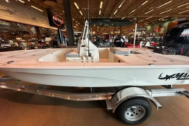 Slide: The Image of 2026 Mako 18 Pro Skiff boat displayed indoors on a trailer. - 5