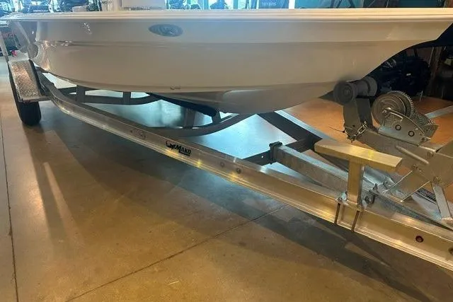 Slide: The Image of 2026 Mako 18 Pro Skiff on trailer in showroom setting. - 11