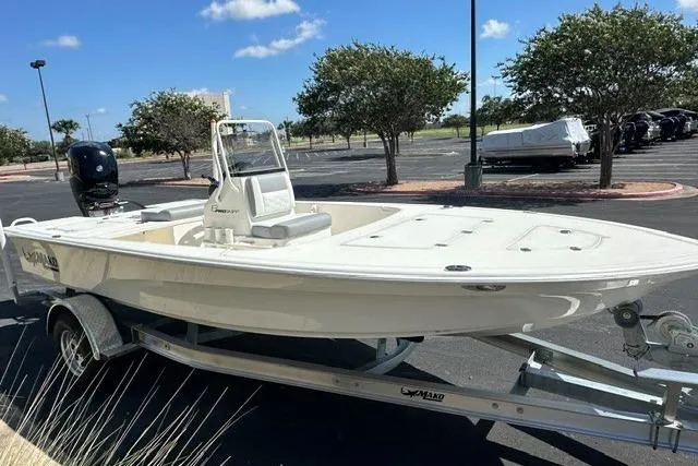 Slide: The Image of 2026 Mako 18 Pro Skiff boat on trailer in sunny parking lot. - 2