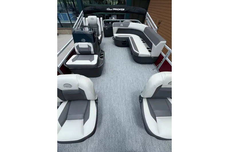 Slide: The Image of 2026 Sun Tracker Bass Buggy 18 DLX pontoon boat interior with spacious seating and modern design. - 2
