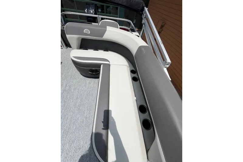 Slide: The Image of 2026 Sun Tracker Bass Buggy 18 DLX boat interior with cushioned seating and cup holders. - 3