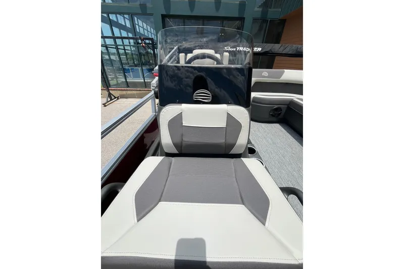 Slide: The Image of 2026 Sun Tracker Bass Buggy 18 DLX boat interior with seating and console. - 6