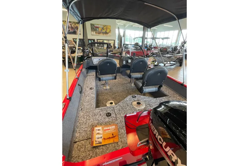 Slide: The Image of 2026 Tracker Pro Guide V-16 WT boat interior with seating and Mercury engine. - 2