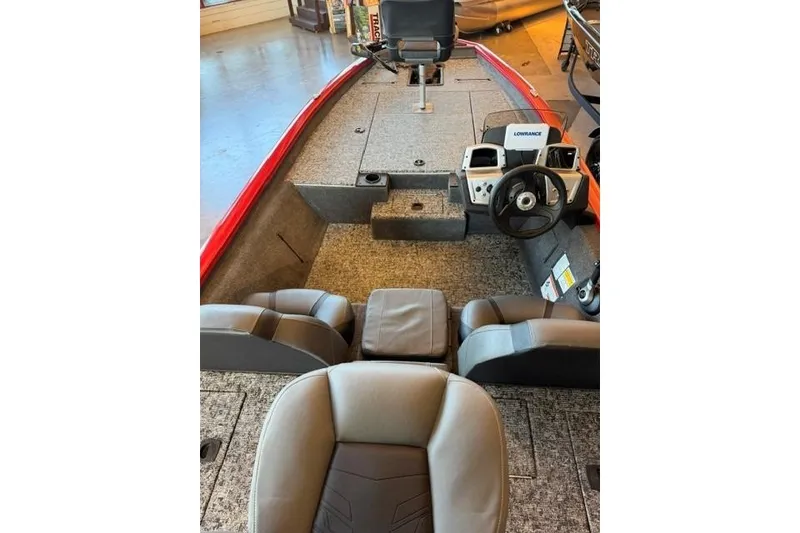 Slide: The Image of 2026 Tracker Pro Team 190 boat interior with steering wheel and seating. - 13