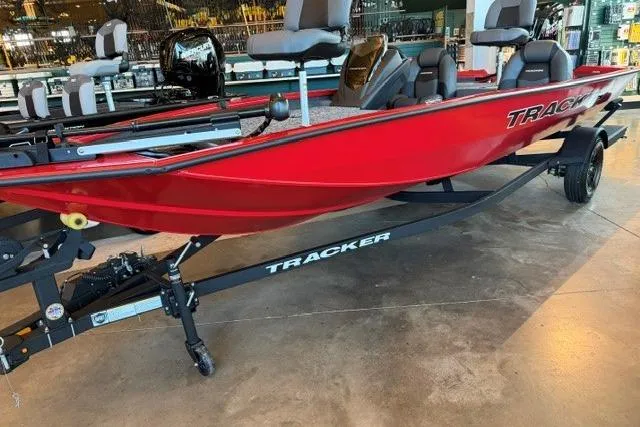 Slide: The Image of 2026 Tracker Pro Team 190 boat in vibrant red on display indoors. - 3