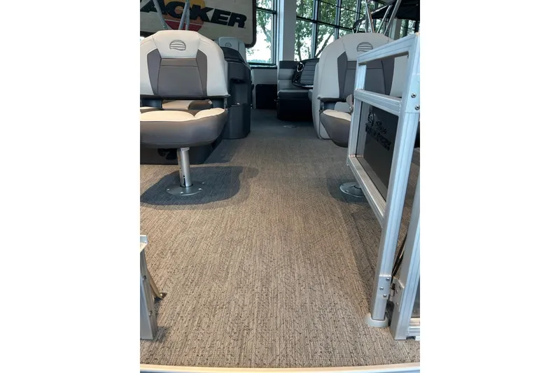 Slide: The Image of Interior view of 2026 Sun Tracker Fishin' Barge 20 DLX with seating and carpeted floor. - 2