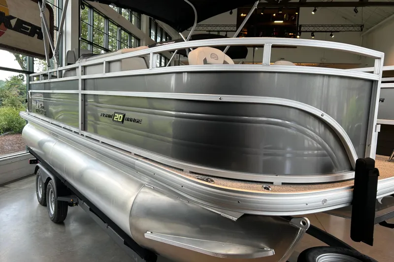 Slide: The Image of 2026 Sun Tracker Fishin' Barge 20 DLX pontoon boat displayed indoors. - 1