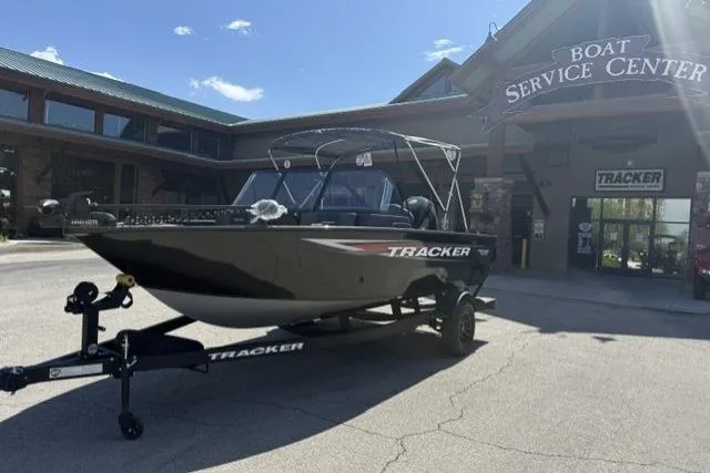 Slide: The Image of 2026 Tracker Pro Guide V-175 Combo boat on trailer outside service center. - 2