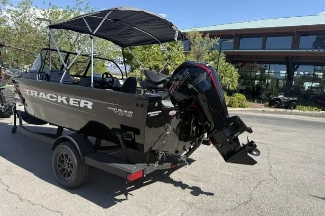 Slide: The Image of 2026 Tracker Pro Guide V-175 Combo boat on trailer, parked outdoors. - 4