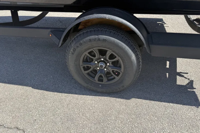 Slide: The Image of Trailer wheel of 2026 Tracker Pro Guide V-175 Combo on asphalt. - 11
