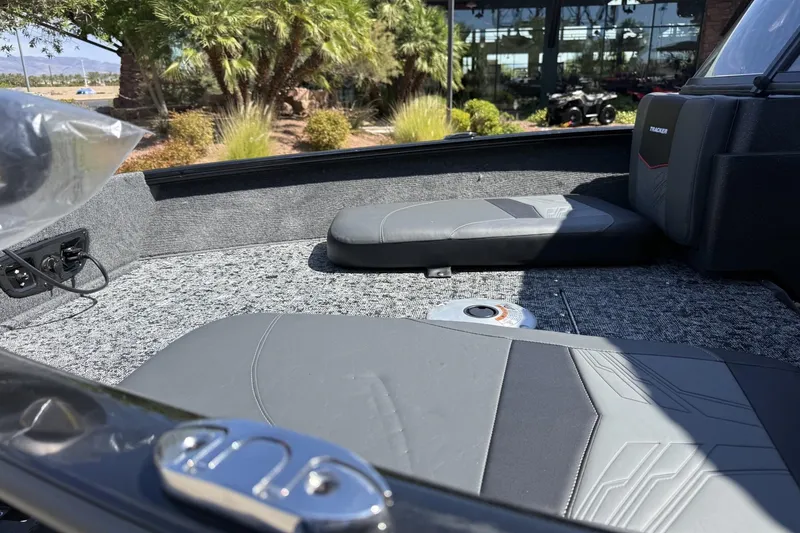 Slide: The Image of 2026 Tracker Pro Guide V-175 Combo boat interior with gray seating and carpeted flooring. - 8