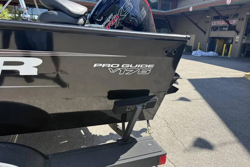 Slide: The Image of 2026 Tracker Pro Guide V-175 Combo boat rear view in outdoor setting. - 6