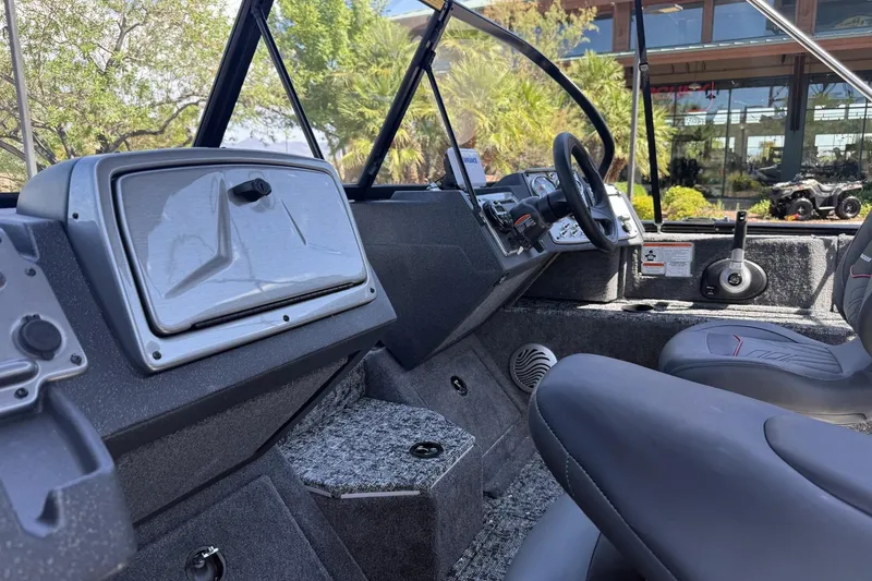 Slide: The Image of Interior of 2026 Tracker Pro Guide V-175 Combo boat with steering wheel and seating. - 9